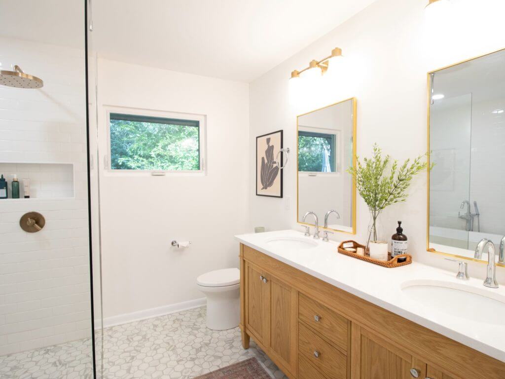 Lansing MI bathroom renovation with wood vanity, glass shower, and hex tile flooring