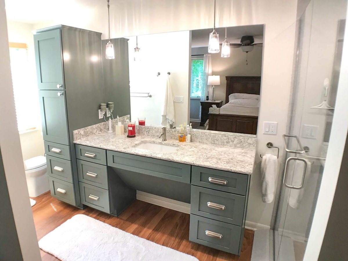 Owosso MI bathroom renovation by Odd Fellows Contracting featuring double vanity and lighting