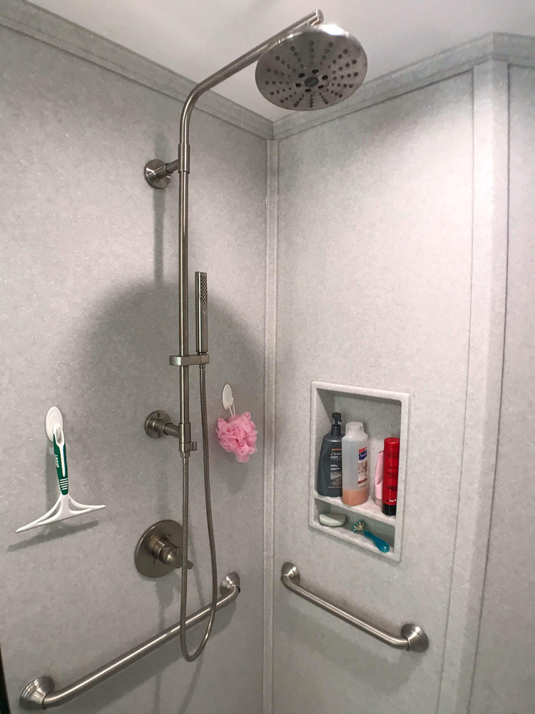 Owosso MI bathroom renovation by Odd Fellows Contracting featuring grab bars and modern shower design