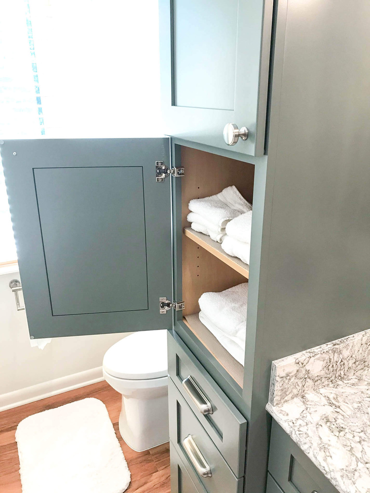bathroom remodel by Odd Fellows Contracting in Owosso MI with custom storage cabinet and shelving