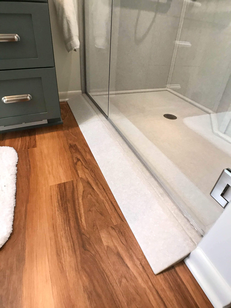 remodeled bathroom shower by Odd Fellows Contracting in Owosso MI with updated tile and fixtures