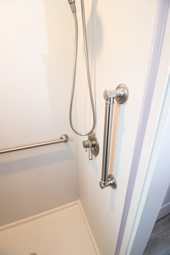 Mason MI bathroom renovation by Odd Fellows Contracting featuring safety grab bar and handheld shower