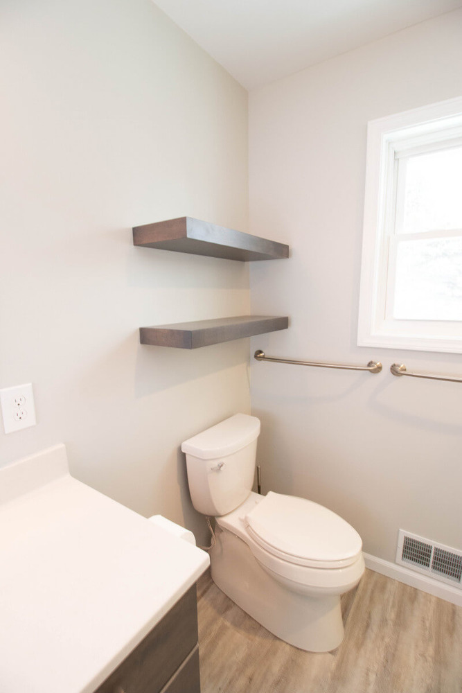 Mason MI bathroom renovation by Odd Fellows Contracting featuring wall-mounted shelves and new flooring