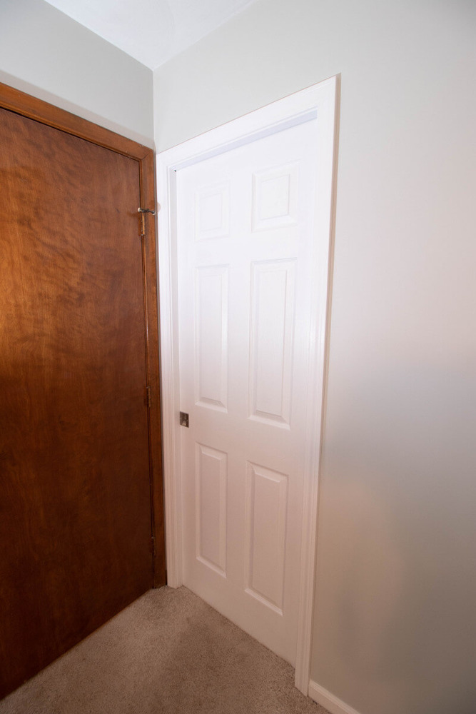 Mason MI bathroom renovation by Odd Fellows Contracting with new white paneled door installation