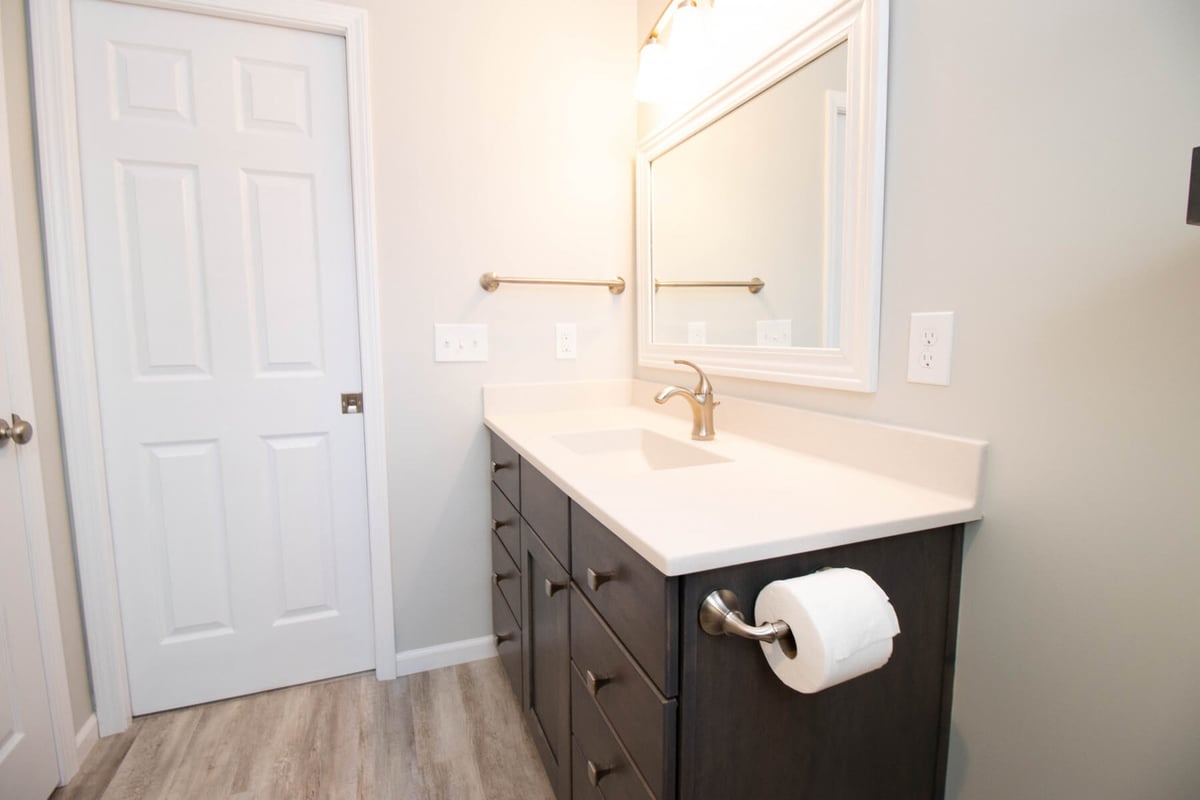 bathroom remodel by Odd Fellows Contracting in Mason MI with updated vanity mirror and lighting