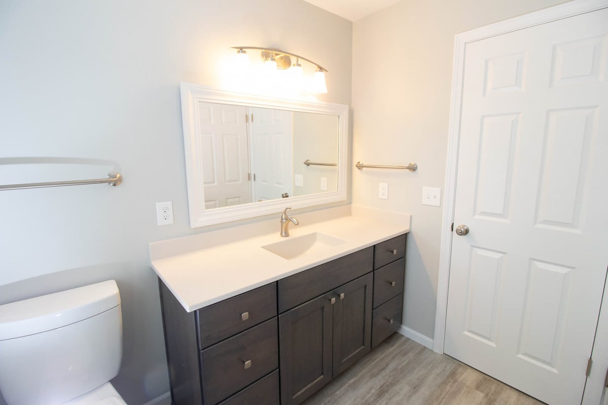 remodeled bathroom by Odd Fellows Contracting in Mason MI with modern vanity and bright finishes