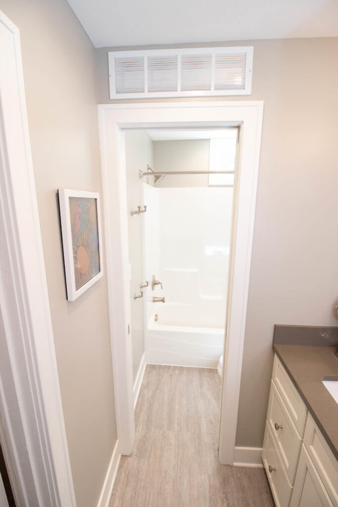 bathroom entry to tub shower by Odd Fellows Contracting in East Lansing MI with new flooring