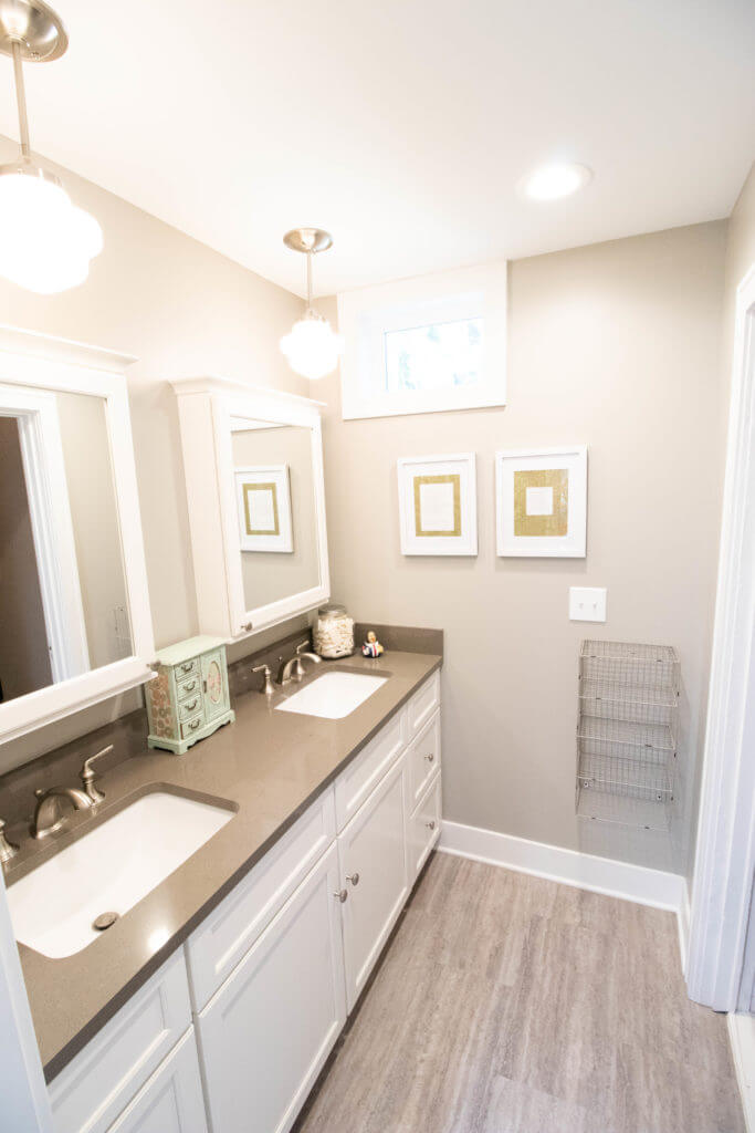 bathroom vanity and storage by Odd Fellows Contracting in East Lansing MI with double sinks and cabinetry