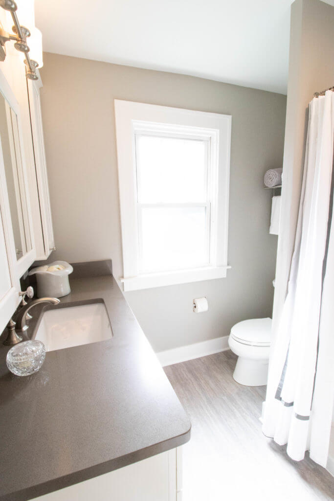 bathroom vanity and toilet layout by Odd Fellows Contracting in East Lansing MI with updated flooring and fixtures