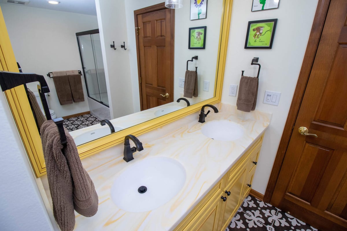 bathroom remodel by Odd Fellows Contracting in Okemos MI featuring double vanity and framed mirror