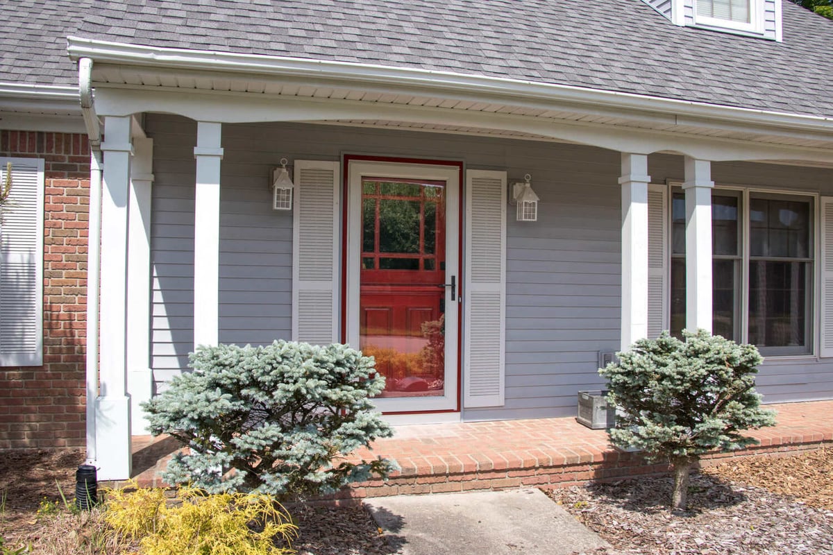 front entry remodel by Odd Fellows Contracting in Okemos MI with red door and covered porch