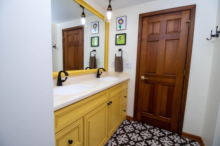 updated bathroom by Odd Fellows Contracting in Okemos MI with dual sinks and patterned tile flooring