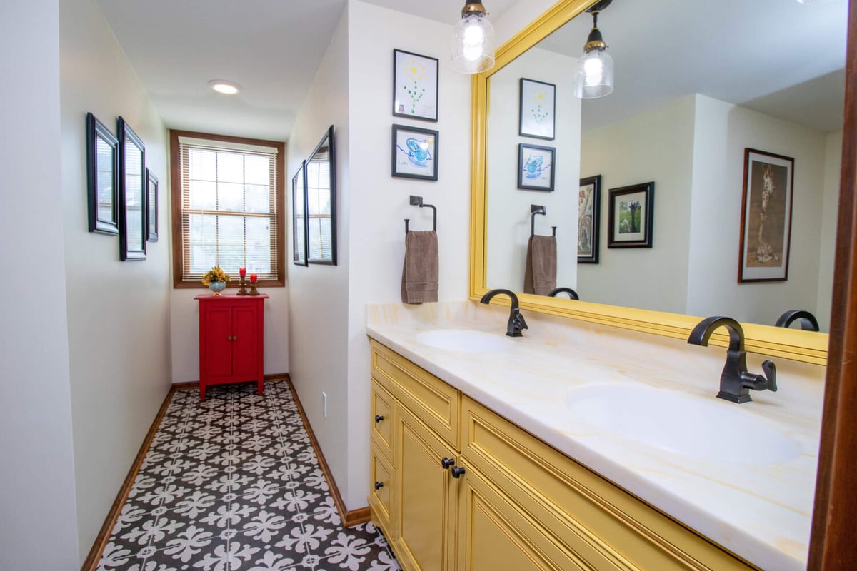 updated bathroom design by Odd Fellows Contracting in Okemos MI with custom cabinetry and large mirror