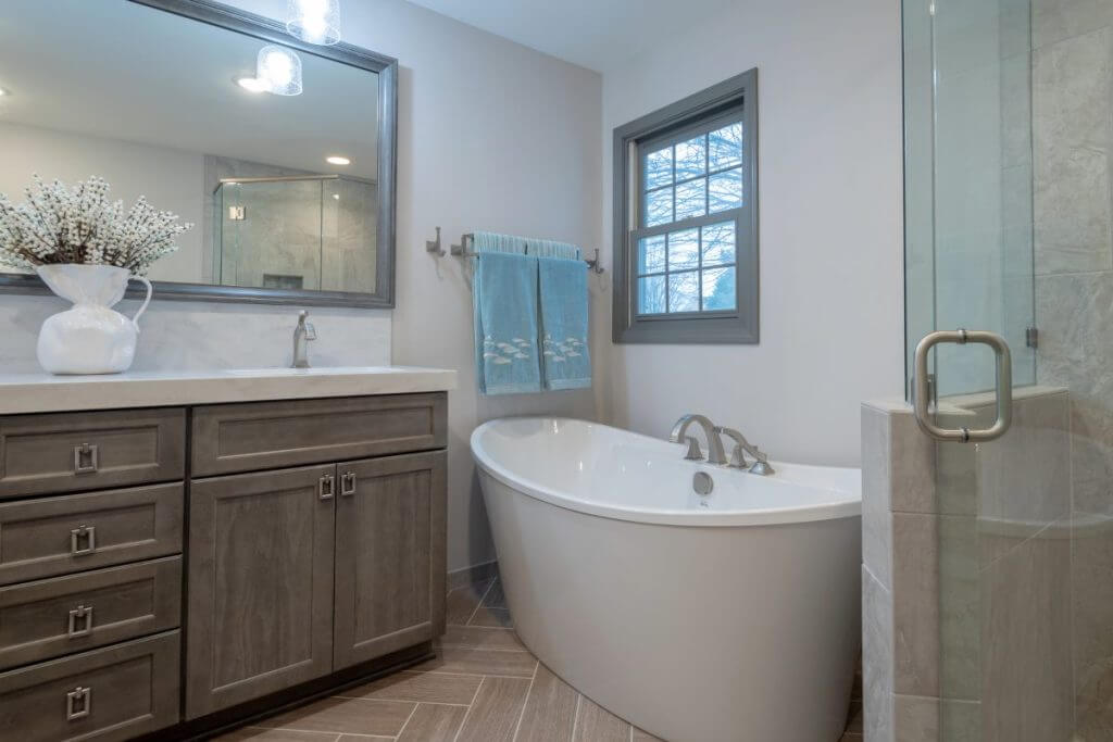 bathroom remodel with custom vanity freestanding tub and glass shower by Odd Fellows Contracting in Okemos MI