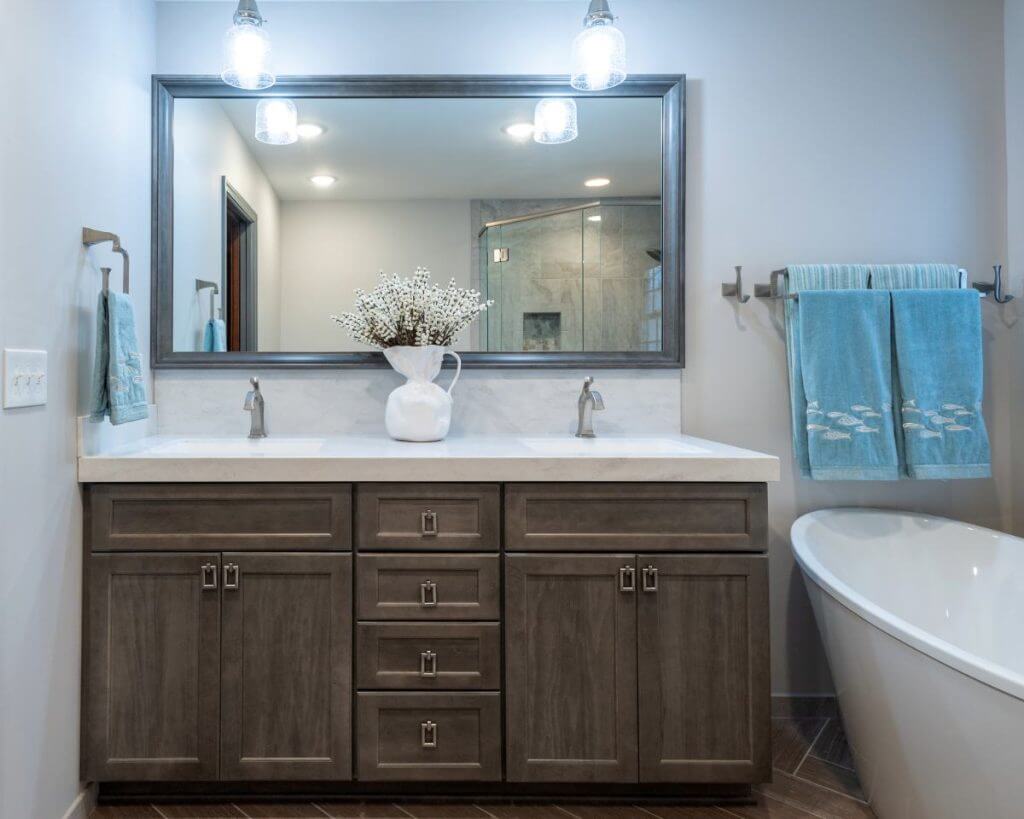 custom bathroom vanity installation with modern lighting by Odd Fellows Contracting in Okemos, MI