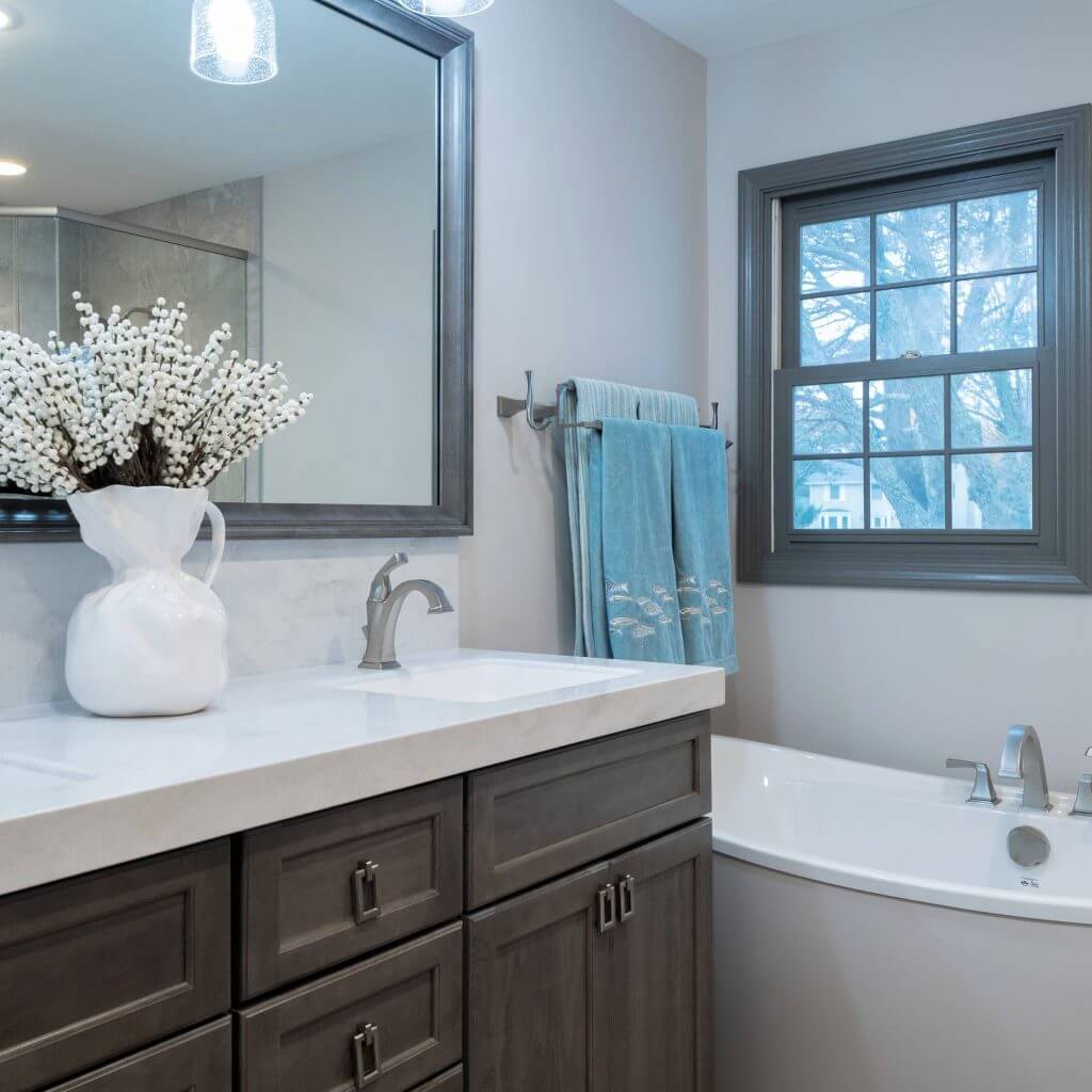 remodeled bathroom with custom vanity and freestanding tub by Odd Fellows Contracting in Okemos, MI