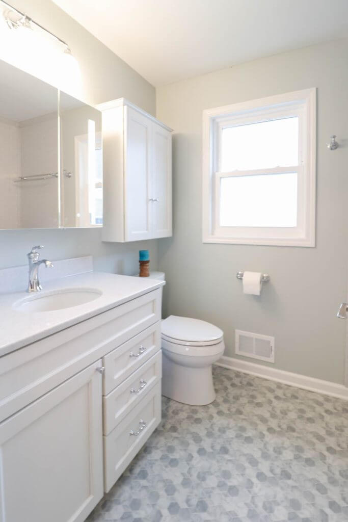 updated bathroom renovation in Williamston, MI by Odd Fellows Contracting featuring chrome fixtures and new cabinetry