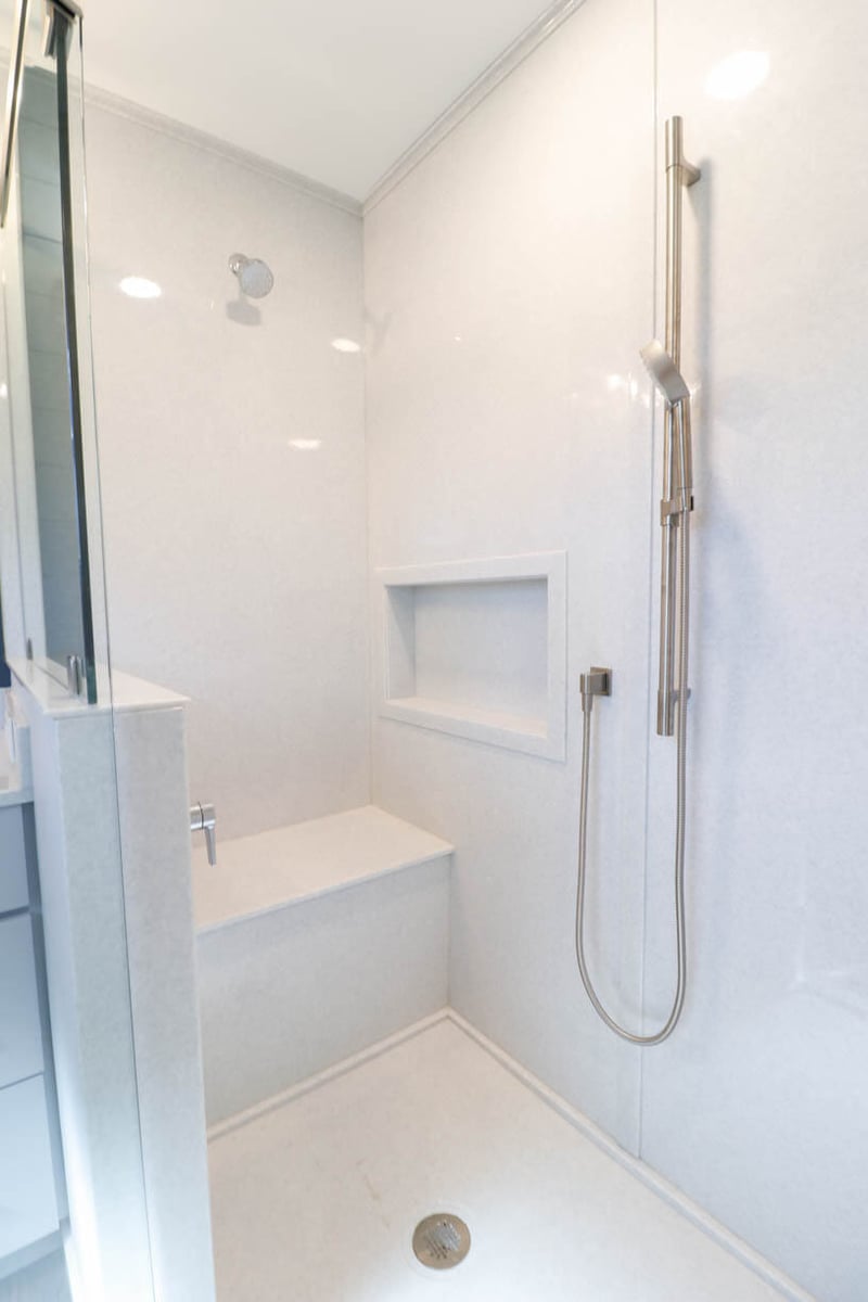 custom shower remodel by Odd Fellows Contracting in Briarwood Okemos, MI featuring frameless glass and wall niche
