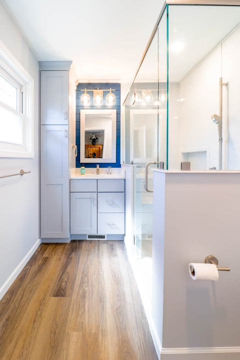 Finished bathroom remodel by Odd Fellows Contracting in Briarwood Okemos, MI with walk-in shower and modern lighting