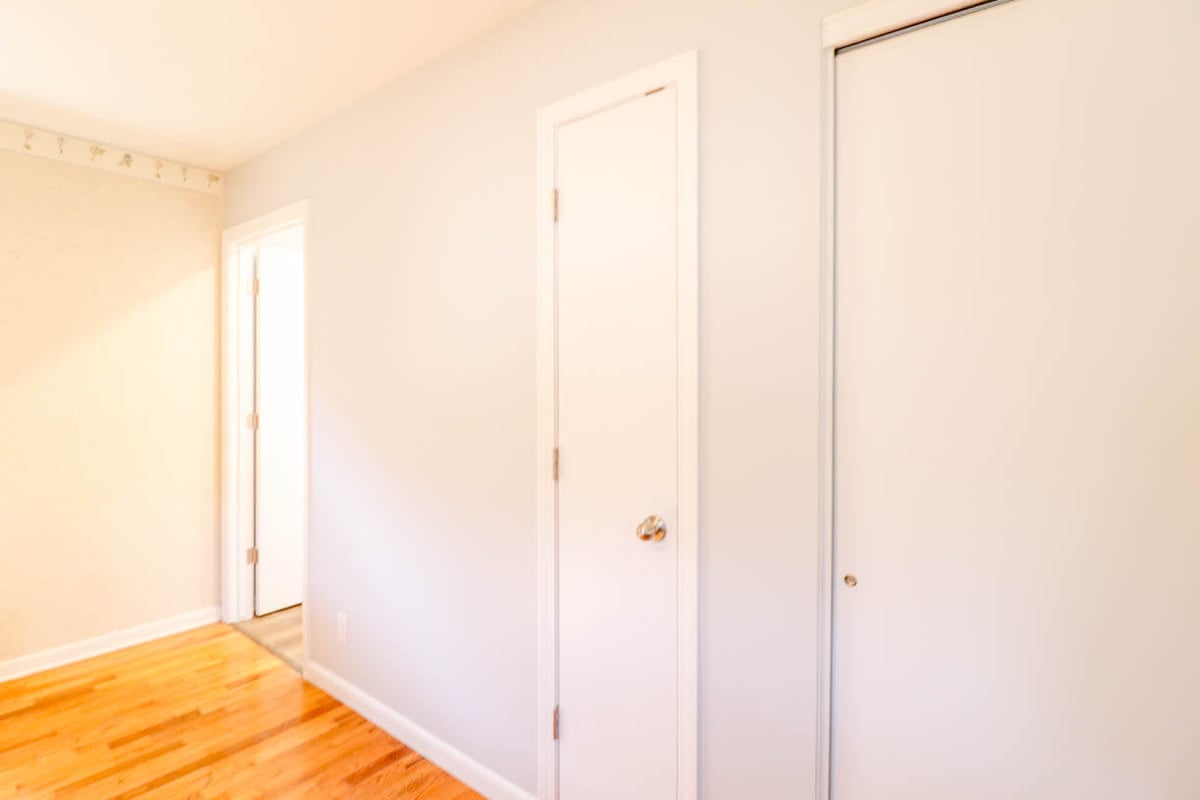 hallway view from bathroom remodel by Odd Fellows Contracting in Briarwood Okemos, MI with new doors and flooring