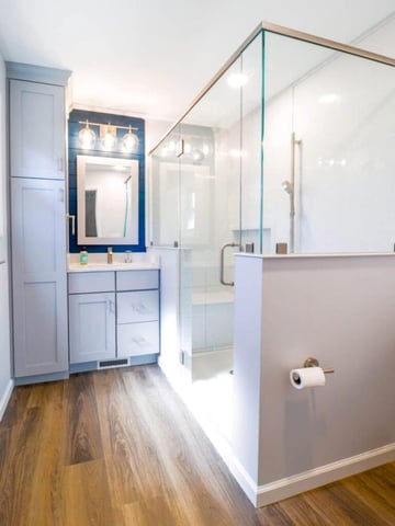 modern bathroom renovation in Briarwood Okemos, MI by Odd Fellows Contracting featuring walk-in shower and wood-look flooring