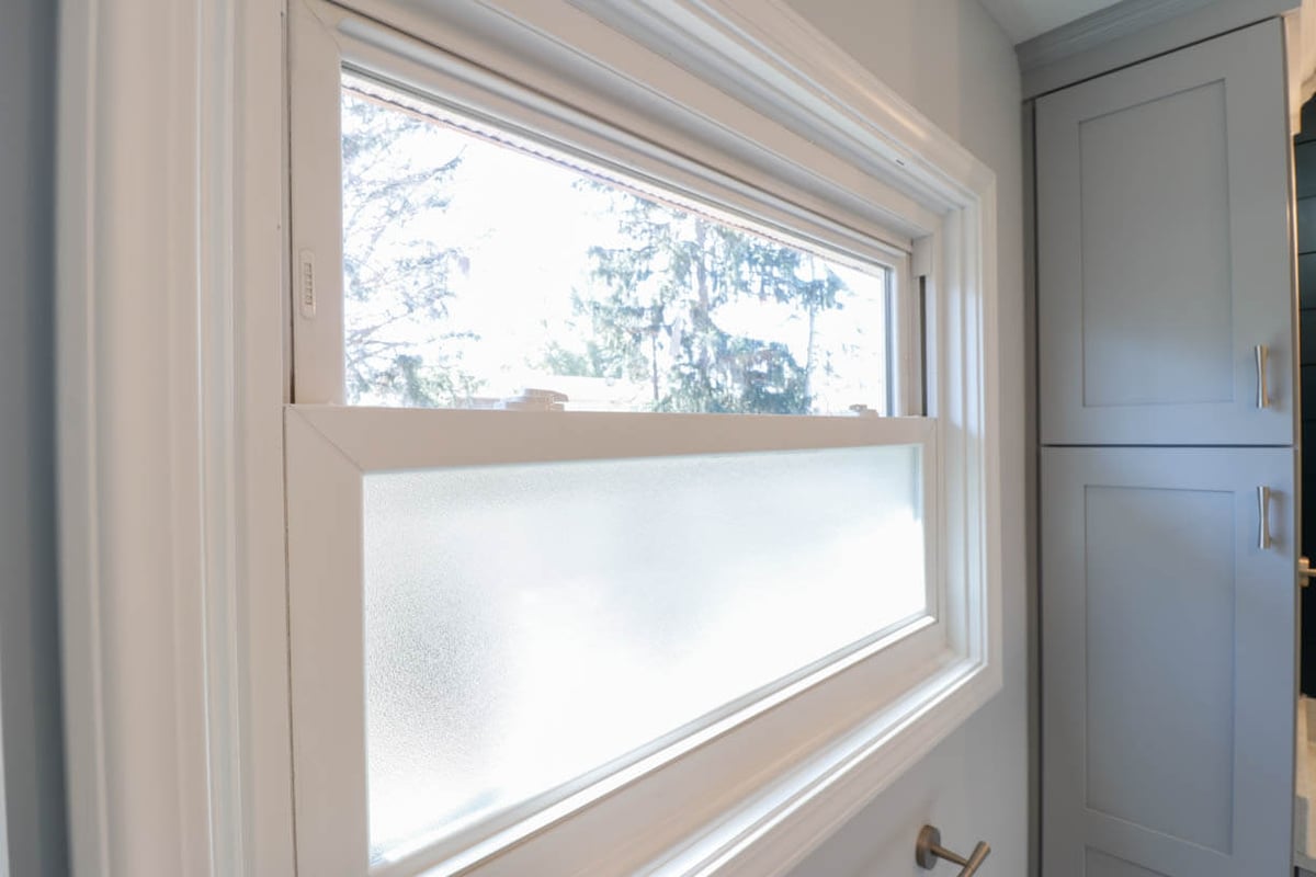 updated bathroom cabinetry and window in Briarwood Okemos, MI by Odd Fellows Contracting