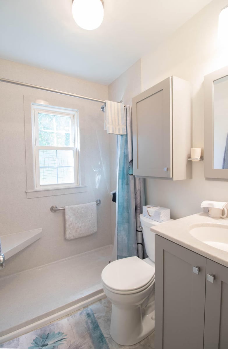 bathroom remodel by Odd Fellows Contracting in Mulliken, MI featuring walk-in shower with acrylic surround, updated vanity, and improved accessibility