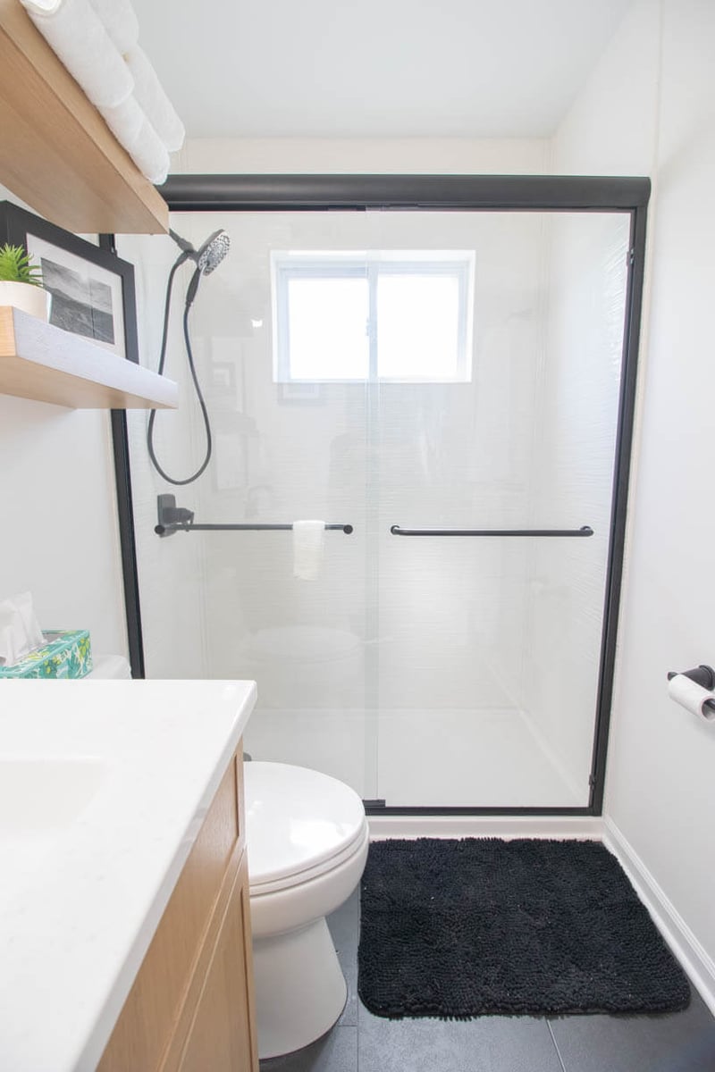 detailed view of glass shower enclosure from bathroom remodel by Odd Fellows Contracting in Holt, MI