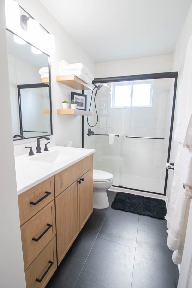 remodeled bathroom in Holt, MI by Odd Fellows Contracting showcasing walk-in glass shower