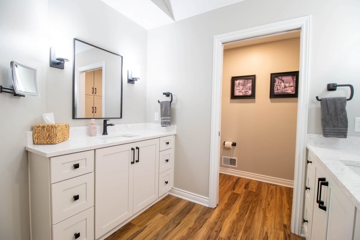 bathroom remodel by Odd Fellows Contracting in Portland, MI featuring white shaker vanity and wood-look flooring