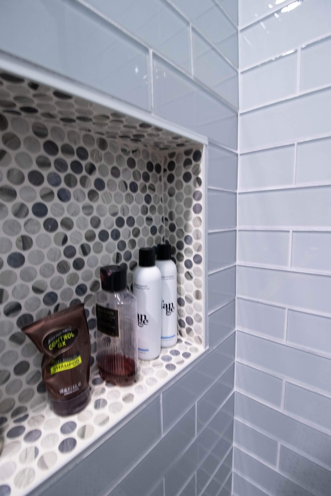 shower niche detail from bathroom remodel by Odd Fellows Contracting in Portland, MI with mosaic accent tile