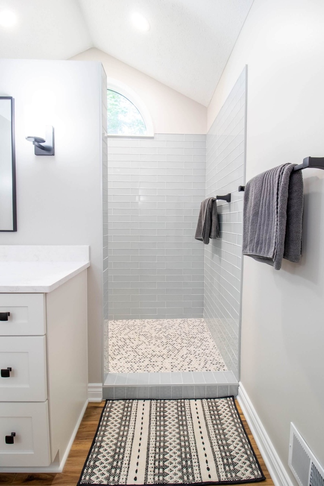 walk-in shower from bathroom remodel by Odd Fellows Contracting in Portland, MI with subway tile walls