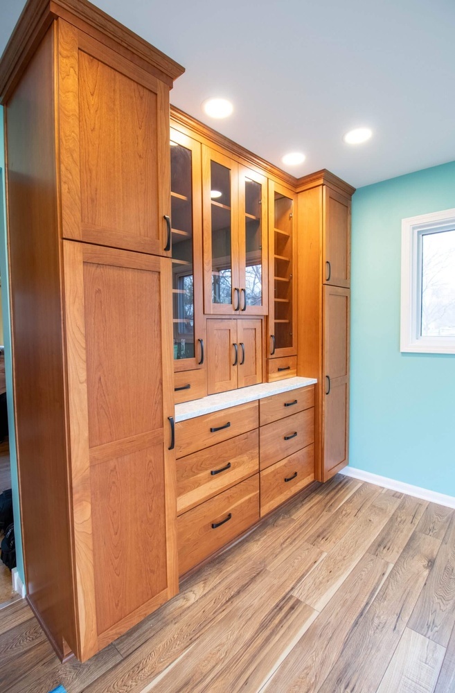 Lansing, MI custom home kitchen by Odd Fellows Contracting featuring floor-to-ceiling wood cabinets