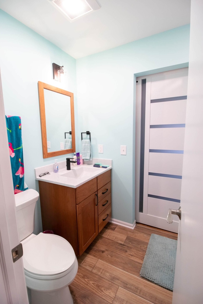 bathroom vanity in Lansing, MI custom home by Odd Fellows Contracting with wood cabinet and white countertop