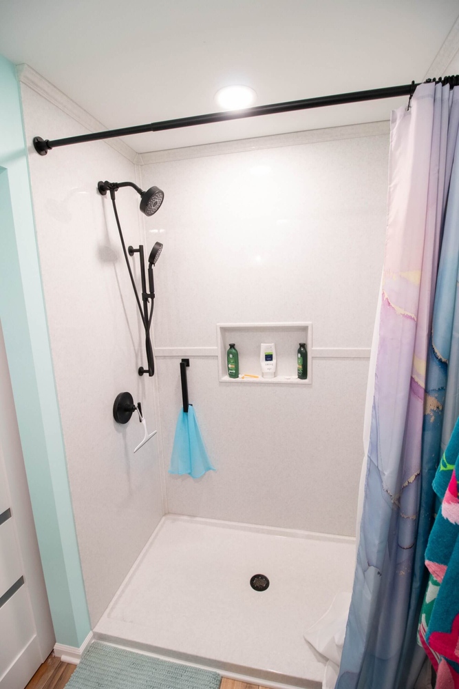 walk-in shower in Lansing, MI custom home by Odd Fellows Contracting with matte black fixtures