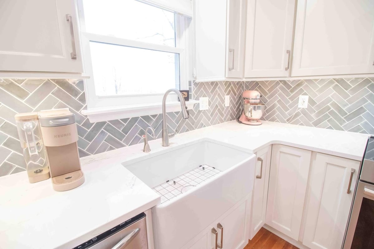 Updated kitchen with apron-front sink and custom cabinetry by Odd Fellows Contracting in Williamston, MI