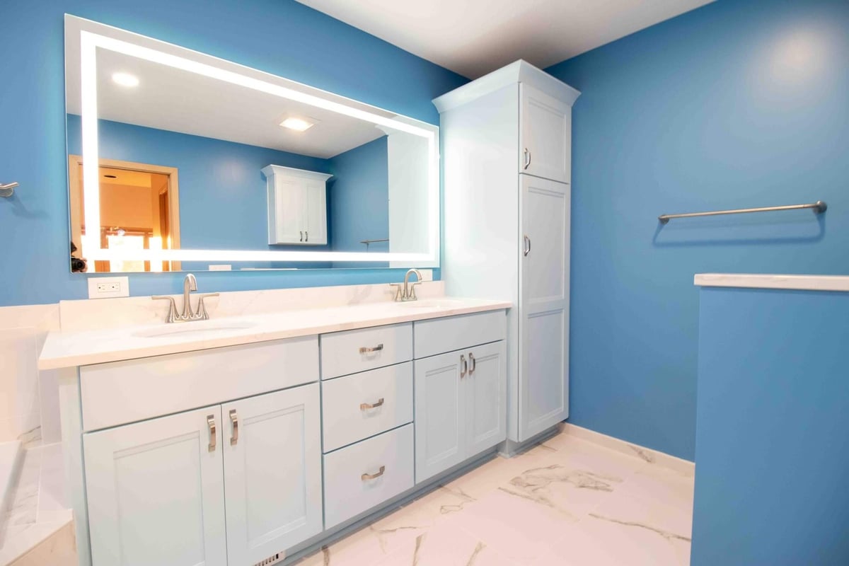 bathroom remodel featuring custom vanity cabinets and modern lighting by Odd Fellows Contracting in Okemos MI