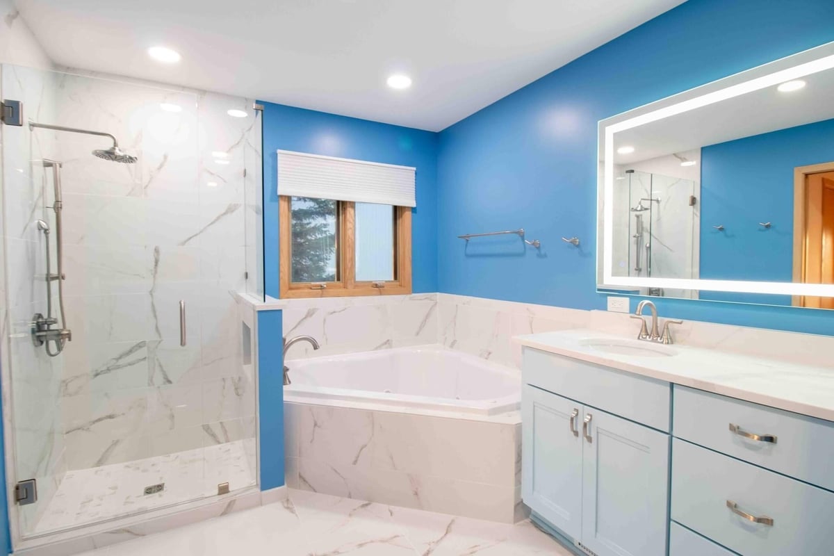 bathroom remodel featuring modern glass shower enclosure and large format tile by Odd Fellows Contracting in Okemos MI