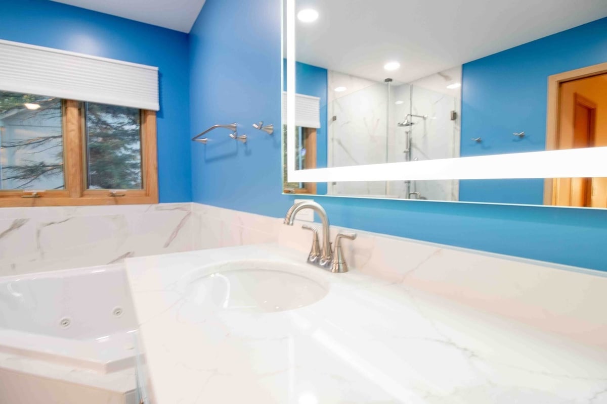 remodeled bathroom vanity area with double sink cabinet and modern finishes by Odd Fellows Contracting in Okemos MI
