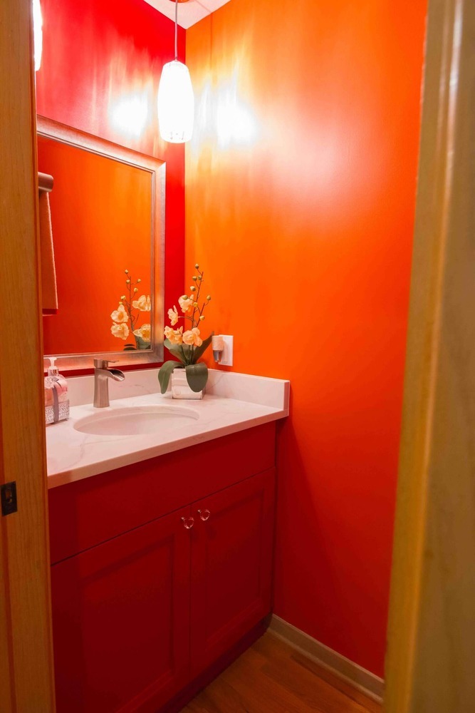 remodeled powder room with bold accent wall and modern vanity cabinet by Odd Fellows Contracting in Okemos MI