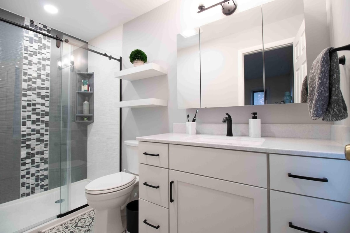 bathroom renovation featuring custom vanity storage and glass shower enclosure by Odd Fellows Contracting in Okemos MI