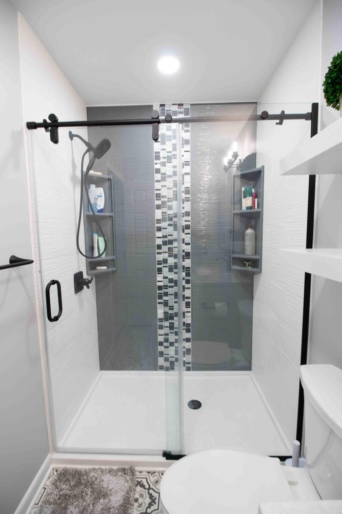 remodeled bathroom walk in shower with glass enclosure and modern tile design by Odd Fellows Contracting in Okemos MI