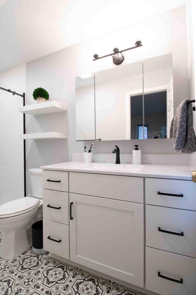 updated bathroom vanity area featuring modern cabinetry and storage by Odd Fellows Contracting in Okemos MI