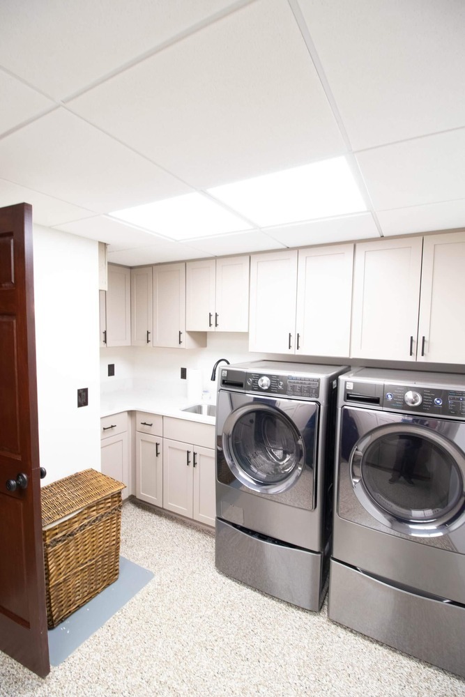 laundry remodel featuring modern cabinetry and upgraded laundry appliances by Odd Fellows Contracting in DeWitt MI