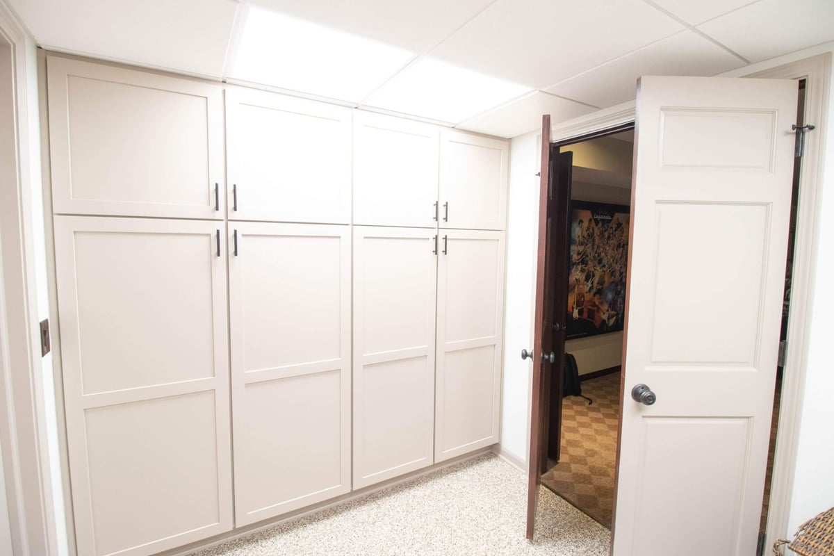 laundry room renovation transformation with built in storage cabinets and countertop workspace by Odd Fellows Contracting in DeWitt MI
