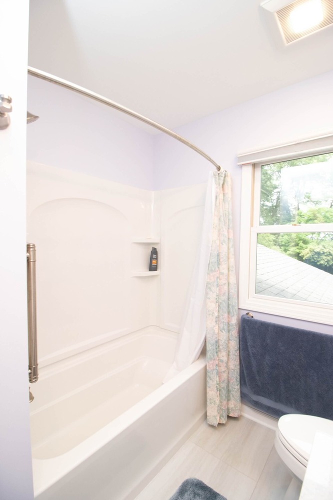 bathroom remodel with updated vanity, tub, and bright interior design by Odd Fellows Contracting in Williamston MI