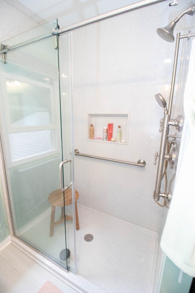 bathroom renovation featuring walk in shower with glass enclosure by Odd Fellows Contracting in Williamston MI