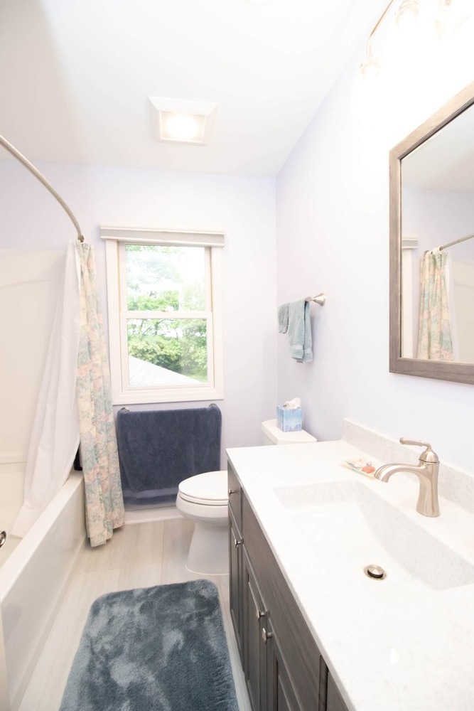 finished bathroom renovation featuring upgraded vanity and sink by Odd Fellows Contracting in Williamston MI
