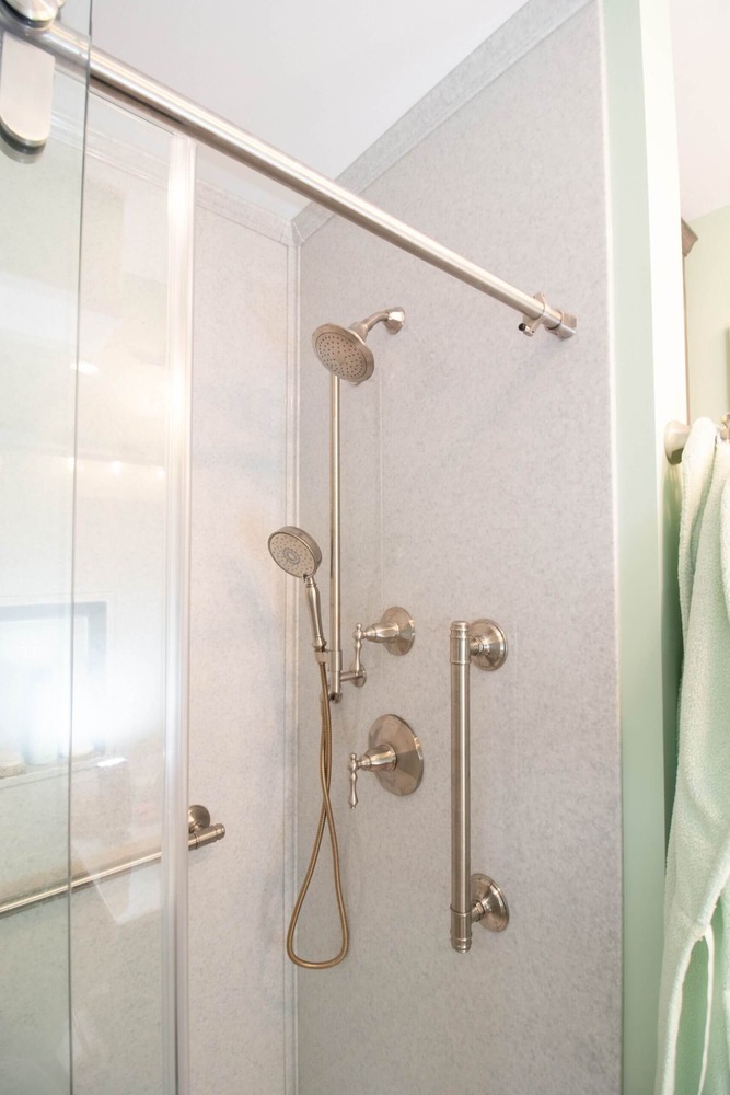 remodeled bathroom shower with glass enclosure and built in niche by Odd Fellows Contracting in Williamston MI