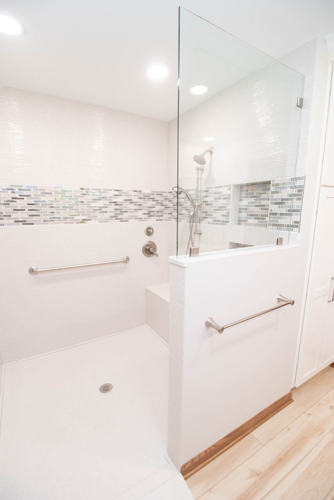 accessible bathroom shower remodel with grab bars and tile surround by Odd Fellows Contracting in Mason MI